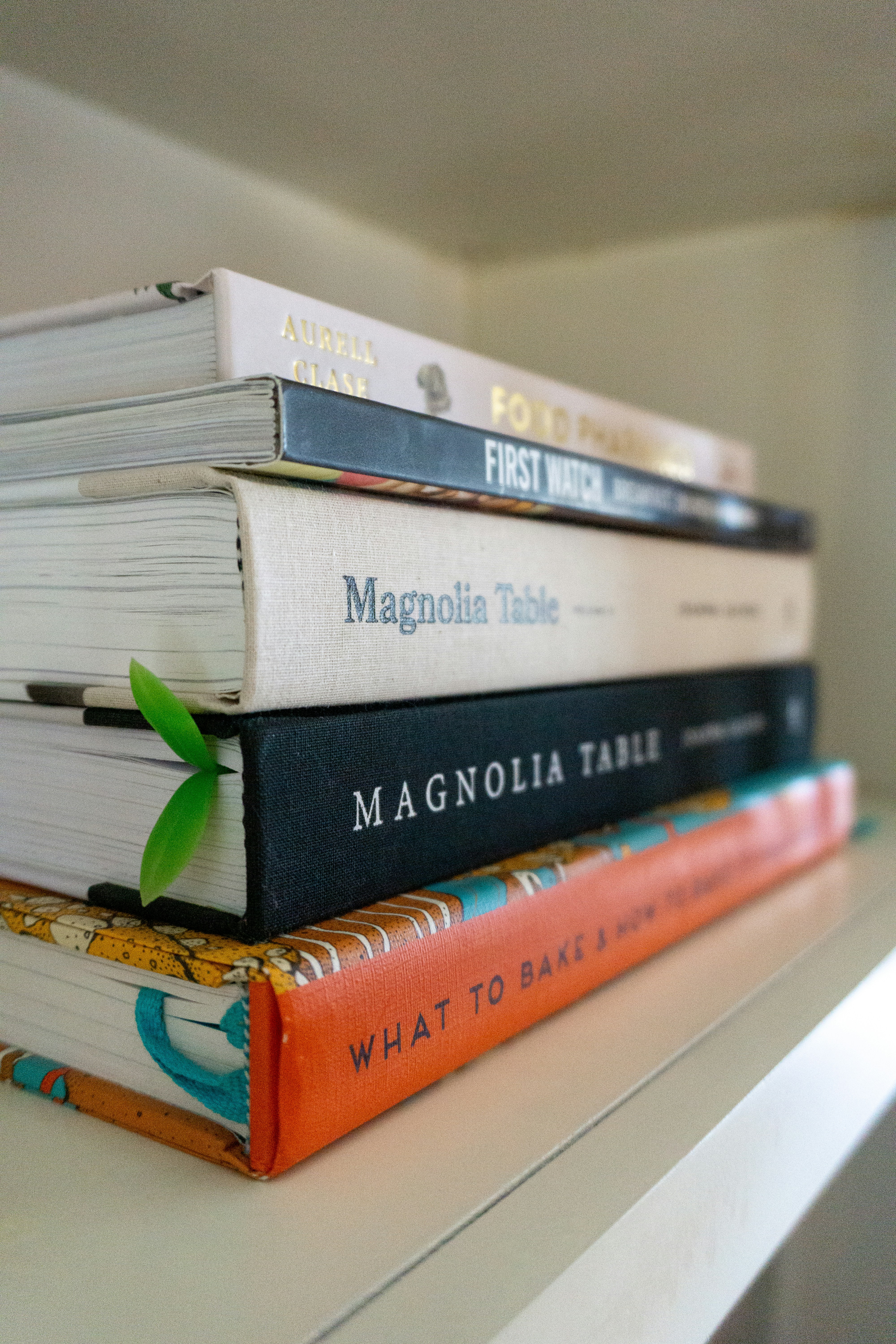 Stack of cookbooks on a shelf